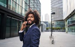 Curly man smiling at street