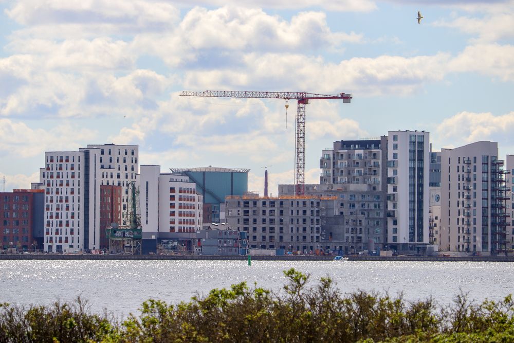 Crane over cityscape across the sea