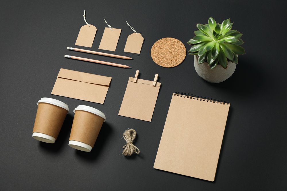 Composition with blank stationery and succulent on dark background, mockup