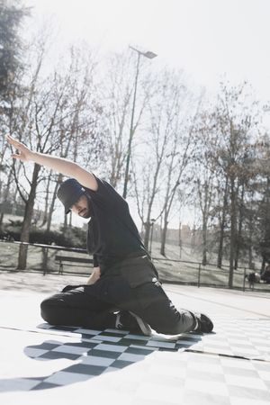 Man dancing break dance in park