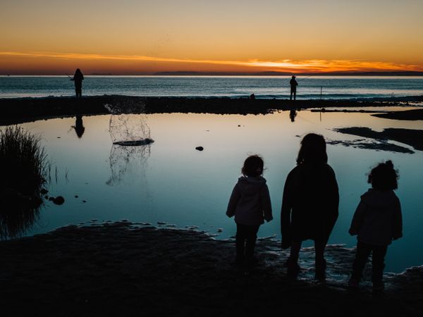back view of little girls looking at sea