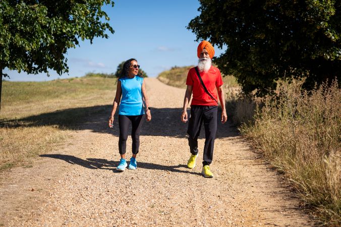 Older Sikh couple walking