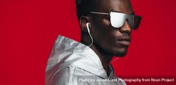 Young guy styled in futuristic outfit in studio 5kxYj4