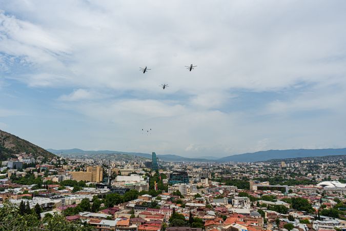 Helicopters fly in the sky of Tbilisi city