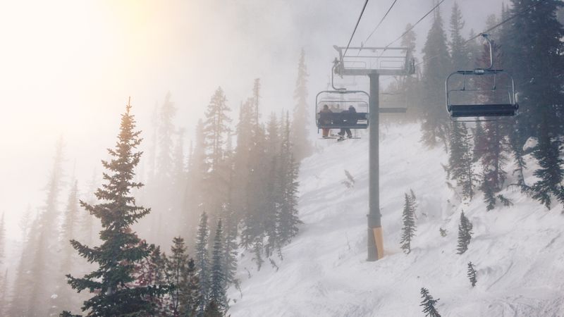 People on chairlift upping on snow mountain