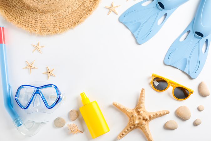 Sea vacation accessories on yellow background, top view