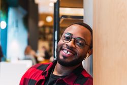 Cheerful Black man in cafe