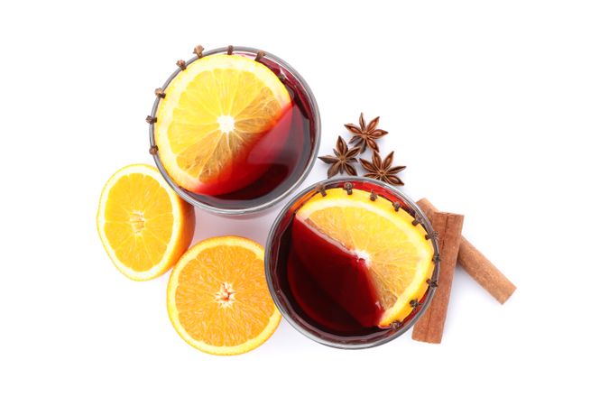 Glasses of tasty mulled wine with orange isolated on plain background