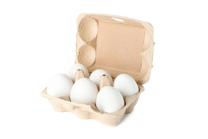 chicken eggs in carton box isolated on blank background