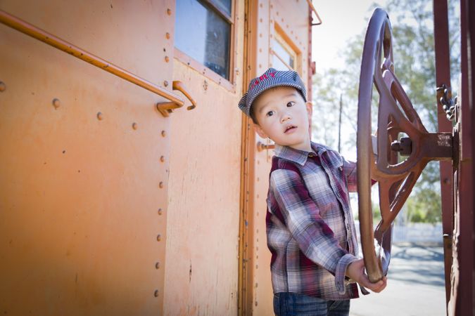 Boy Having Fun on Railroad Car