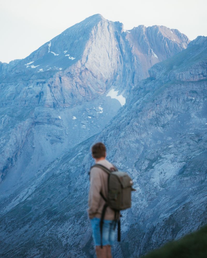 Unrecognizable man with backpack hiking in Pyrenees mountains