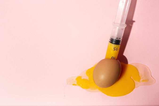 Syringe sucking yolk out of raw egg