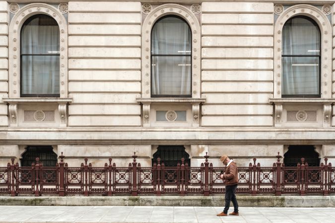 Male tourist walking near old building