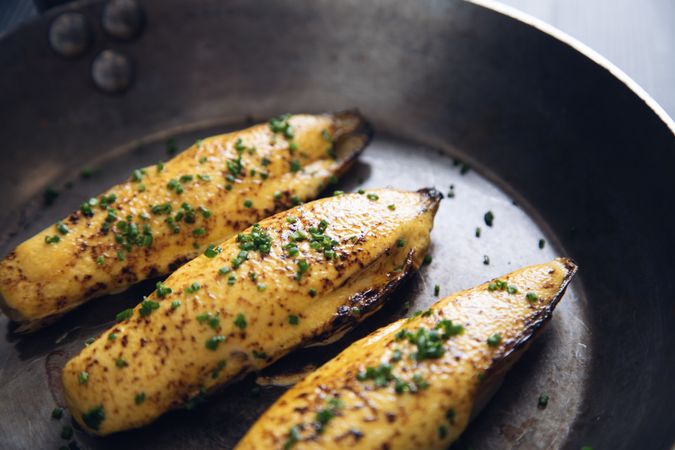 Endives with hollandaise sauce au gratin in pan on table