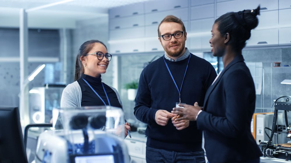 Multi Ethnic Team of Male and Female Leading Scientists Discussing Innovative Robotics Technology.