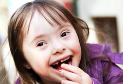 Closeup of a young brunette girl in jacket smiling