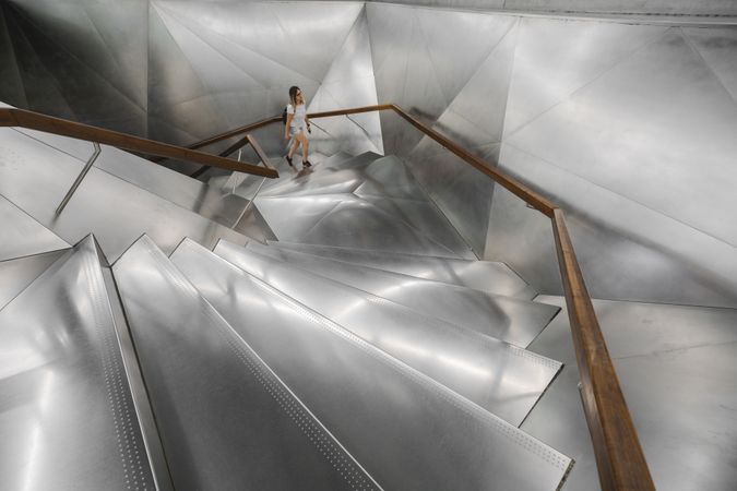 Woman walking on contemporary metal stairway