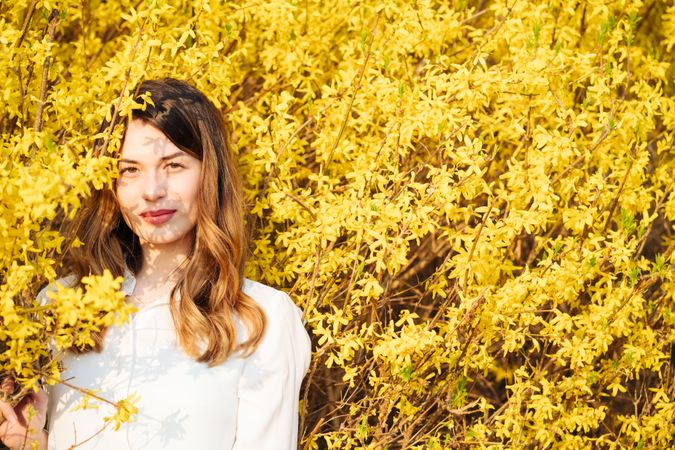 woman amidst yellow flowers