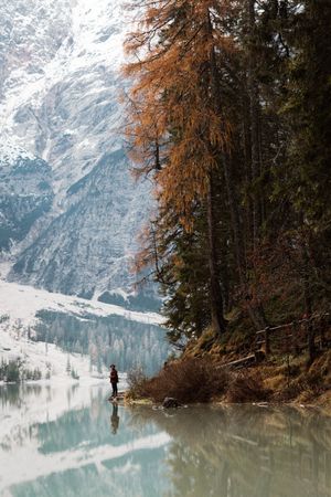 Man delighting in views near lake and mountains