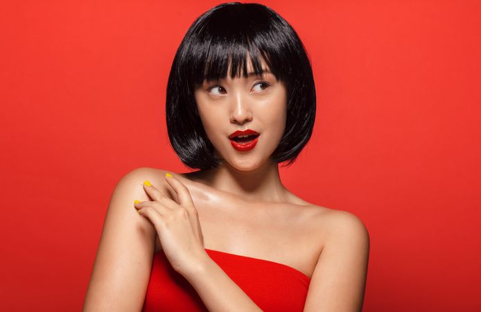 Stylish Korean female model against red background