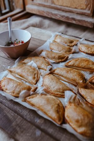 Baking tray with composed freshly baked pies patty