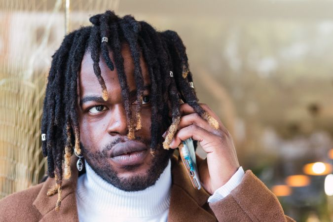 Black man speaking on mobile phone