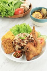 Indonesian chicken dish served with rice, salad and spicy condiment with soup