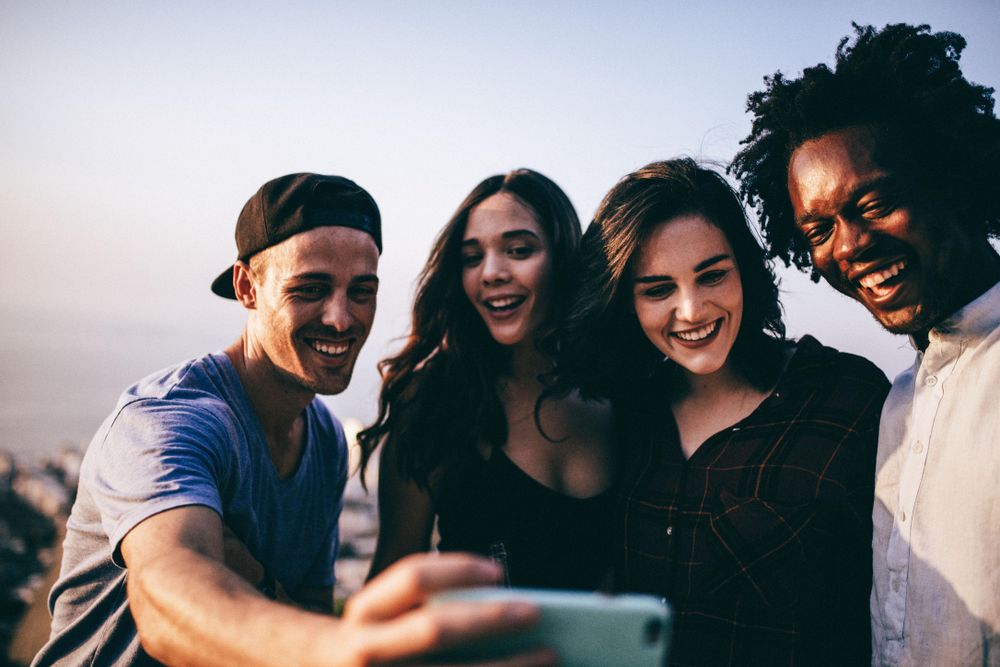 Group of friends taking a selfie outside