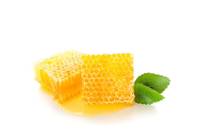 Honeycombs and leaves isolated on blank background