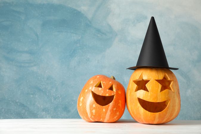 Funny pumpkins on wooden background, space for text
