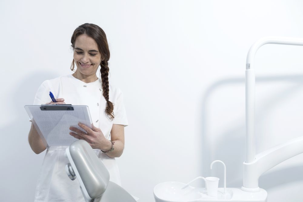 Portrait of confident doctor holding clipboard with documents