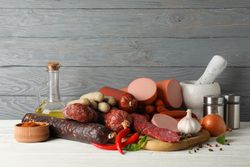 Board of cured meats with garlic, spices and herbs