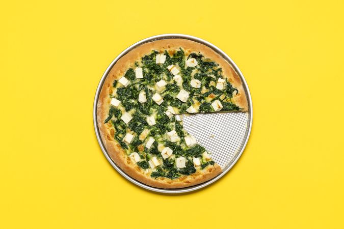 Vegetarian pizza minimalist on a yellow background