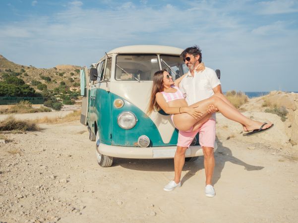 Man holding woman in hands and smiling