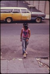 Trendy hispanic man crossing the street in New Jersey 1974