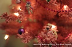 Pink Christmas tree with toy pony ornaments 5k6v60