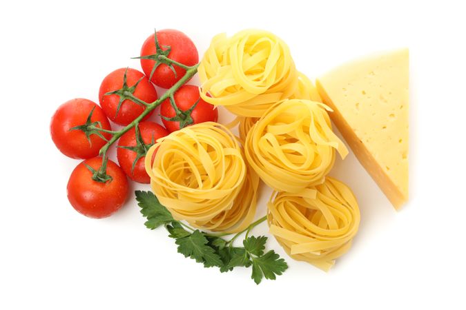 Tasty pasta and ingredients isolated on plain background