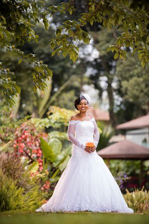 Bride standing on green grass in a garden