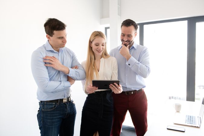 Men and woman with gadgets in office
