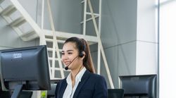 Female speaking on headphones in call center