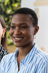 Delighted Black woman with short hair looking away