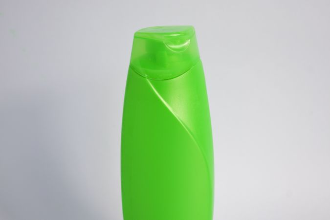 Green mockup shampoo or body wash bottle with copy space