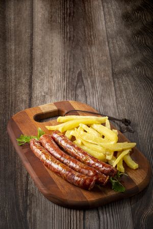 Grilled German sausage with french fries.
