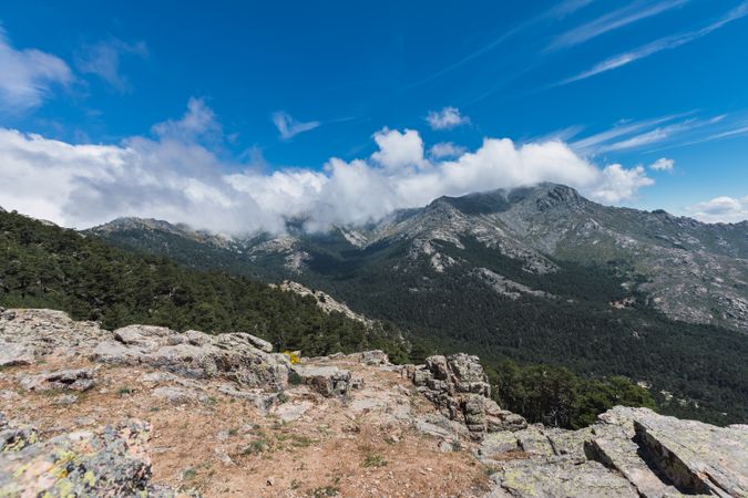 Breathtaking white clouds above hills with greenery
