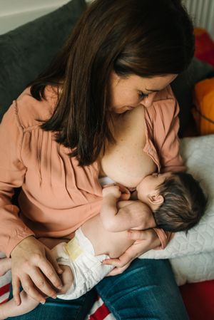 Mom breastfeeding at home