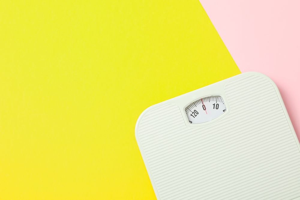 weigh scales on two tone background, space for text