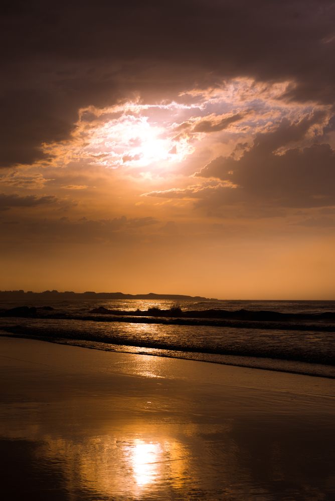 Beautiful evening sky over waving sea and shore