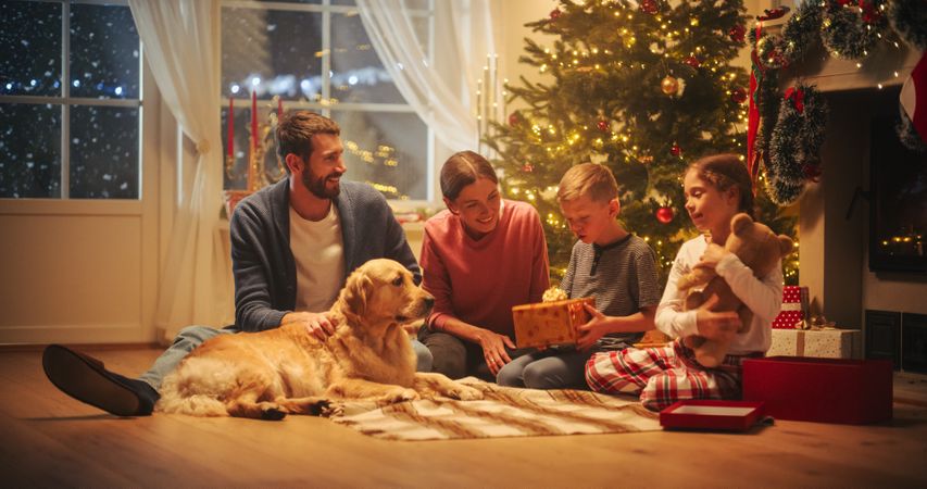 Happy Children Getting New Toys from Mom and Dad, with Family Dog Sharing the Moment