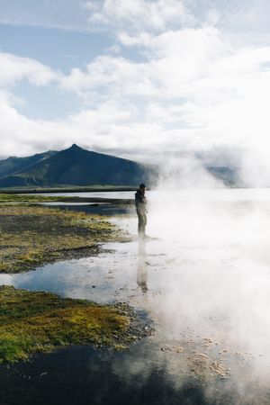 Man at geyser on overcast day, portrait