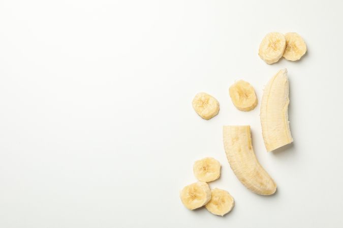 Bananas on neutral background, top view. Fresh fruit